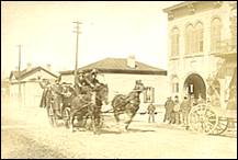 A group of people standing next to a horse and buggy

Description automatically generated with medium confidence