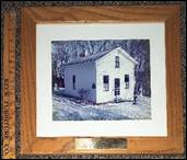 A framed picture of a house

Description automatically generated with low confidence