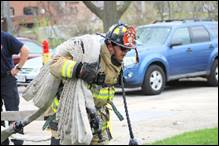 A firefighter putting out a fire

Description automatically generated with low confidence