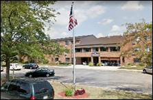 A flag on a pole in front of a building

Description automatically generated with medium confidence