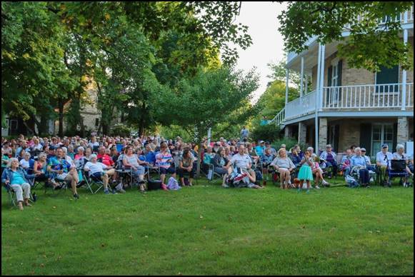 A large group of people sitting on the lawn

Description automatically generated with low confidence